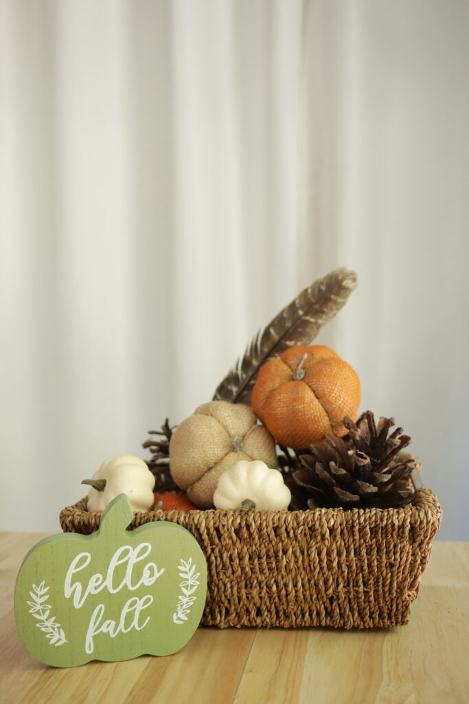 fall decor pumpkins pinecones and a hello fall sign