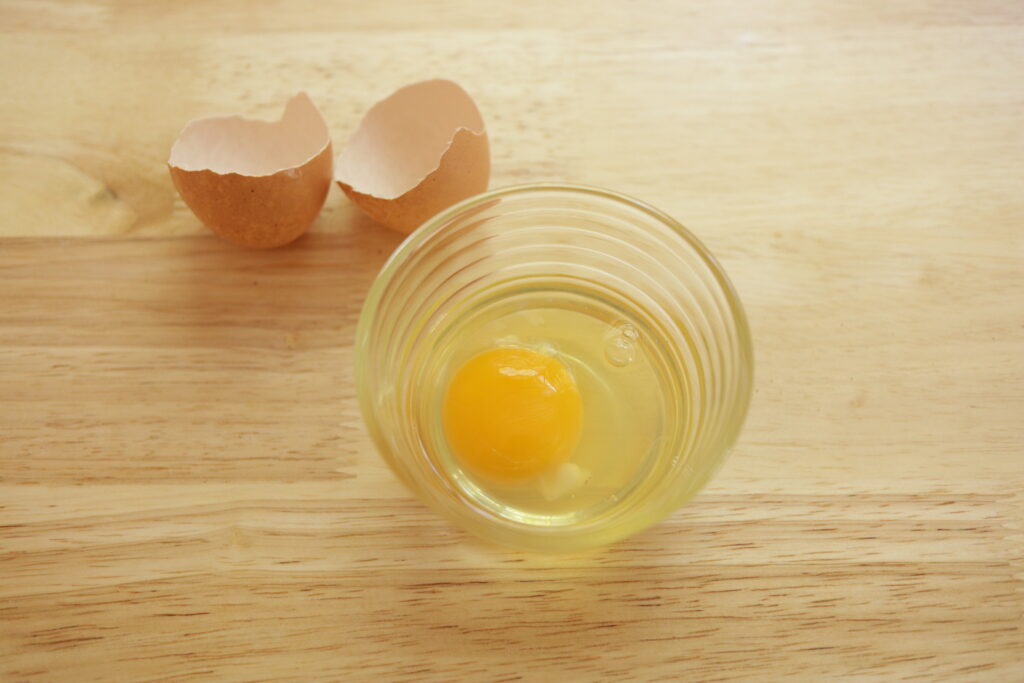 cracked egg in a bowl 