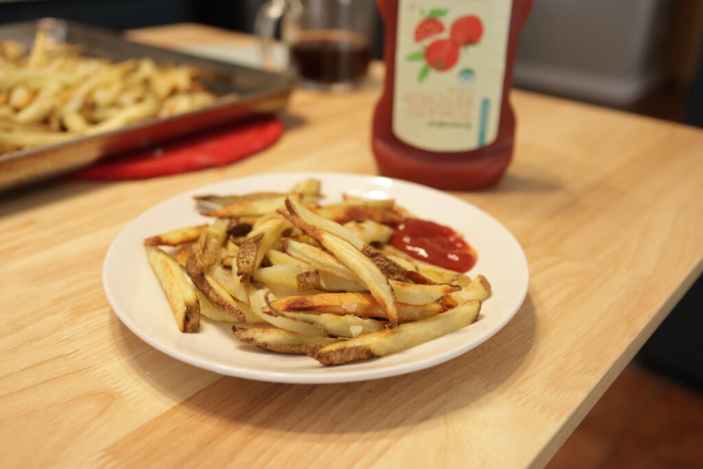 homemade fries on a plate with ketchup